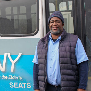 Male Pace driver standing in front of Pace shuttle