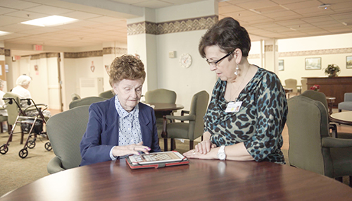 employee and participant playing checkers together