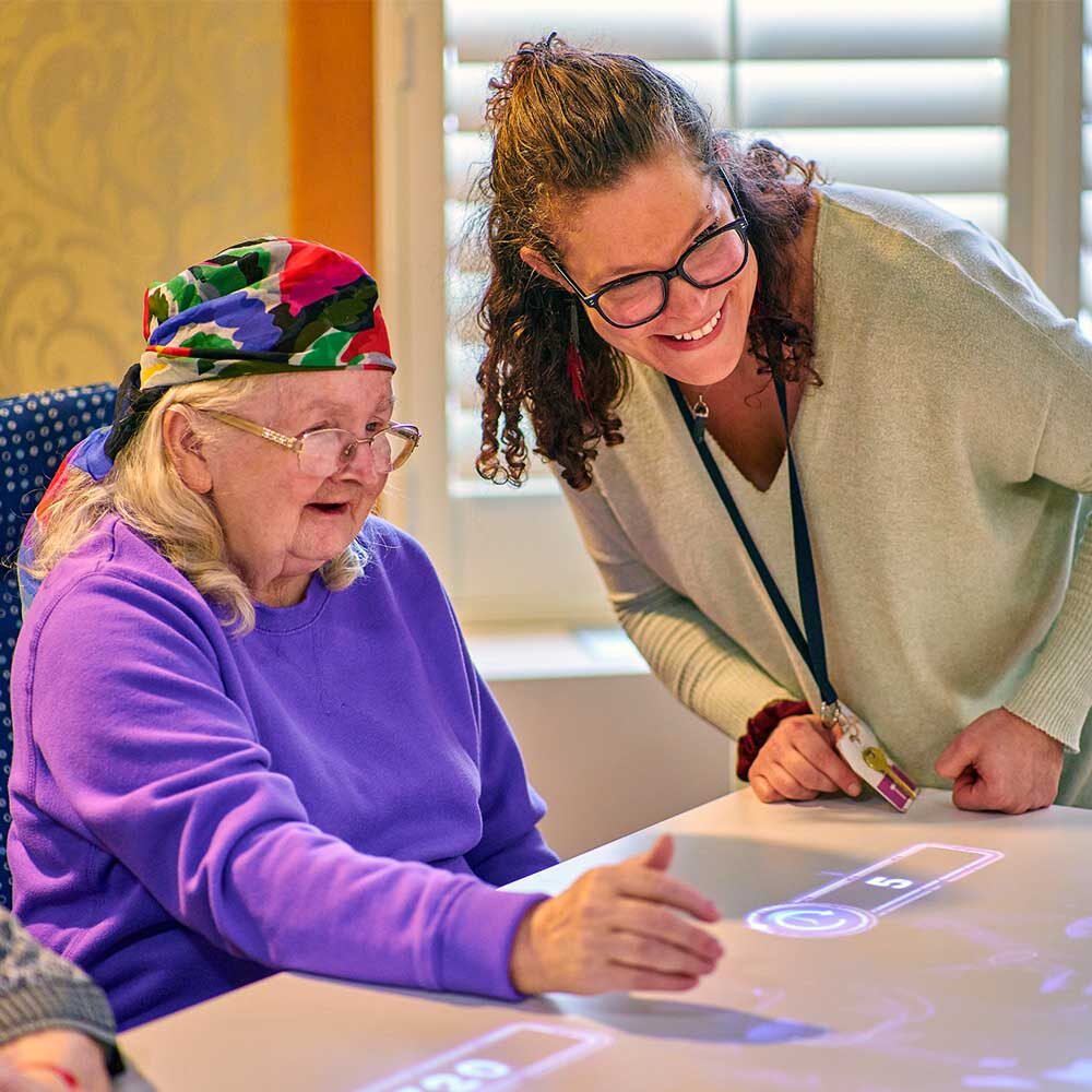 Resident and Loretto Employee interacting