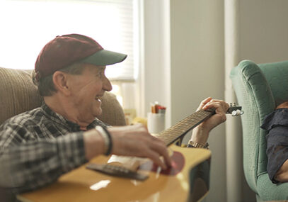 Resdient and daughter hanging out and playing the guitar